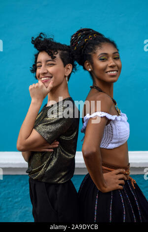 Two young black latina women showing their braided hair. Hispanic