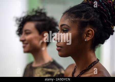 Two young black latina women showing their braided hair. Hispanic girls  with cool box braids green hairstyle Stock Photo - Alamy