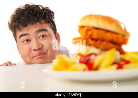 Small fat boy want to eat hamburgers Stock Photo