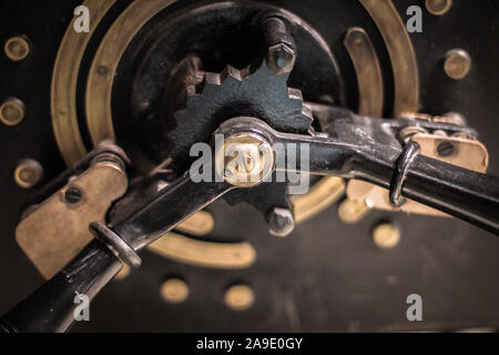 Painted black, steel and brass gear mechanism with electrical contacts. Stock Photo