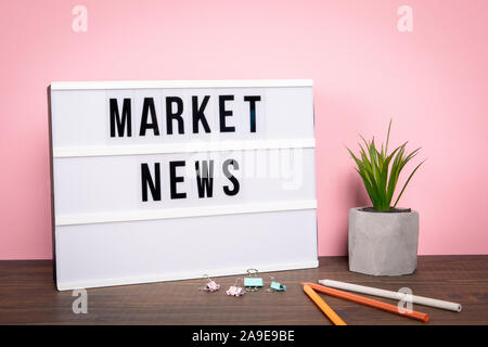 Market news. Business, Reports, Tips and Tutorial concept. White lightbox on a wooden table Stock Photo