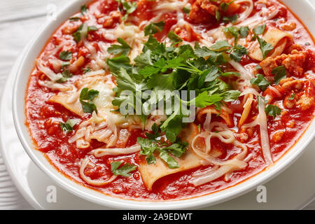 hearty lasagna in a comforting soup loaded with meat, tomatoes and Italian herbs and the melty cheese, close-up Stock Photo