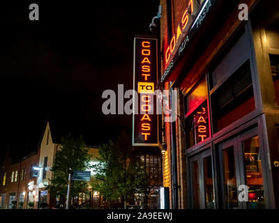 The neon sign of Coast to Coast restaurant and the Queen of Iceni in the background located at the Riverside complex of Norwich Stock Photo