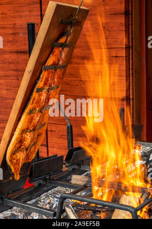 Flame-grilled salmon, Christmas market in the Old Town of Heidelberg, Heidelberg, Baden-Wuerttemberg, Germany, Europe Stock Photo