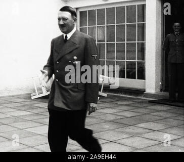 Eva Braun Collection (osam) - Adolf Hitler walking to greet someone outdoors ca. 1930s or 1940s Stock Photo