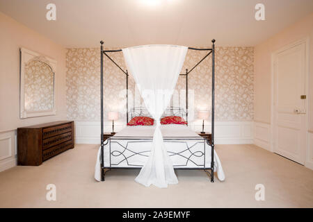 Romantic four-poster bed Stock Photo