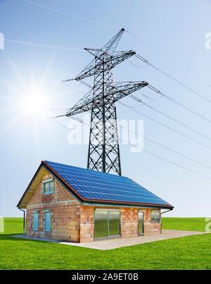 House under high voltage line Stock Photo