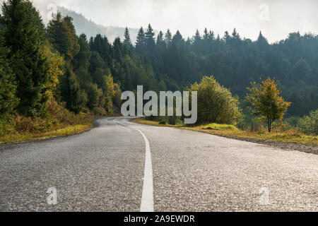 Empty road in mountains, foggy morning Stock Photo
