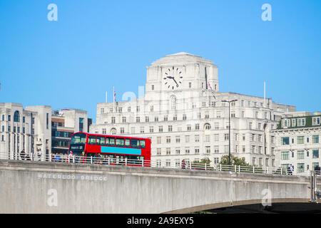Waterloo Bridge with a passing bus and facade of Shell Mex House in the background in London Stock Photo