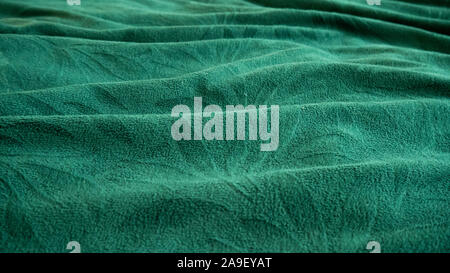 Waves made of turquoise fabric. Beautiful texture Stock Photo
