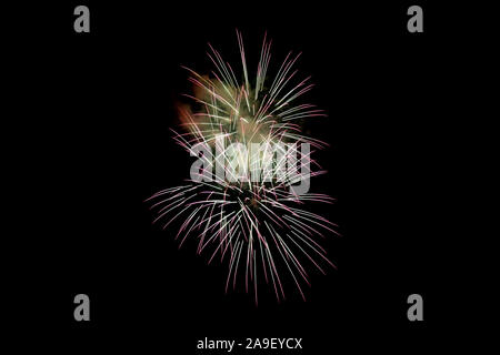 White Pink Sparkling Fireworks Background on Night Scene. Abstract color fireworks background and smoke on sky Stock Photo