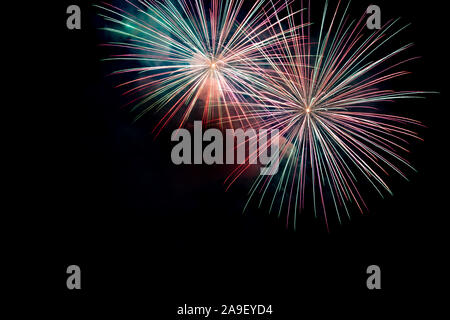 Green Red Sparkling Fireworks Background on Night Scene. Abstract color fireworks background and smoke on sky Stock Photo