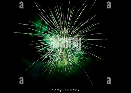 Two Green Sparkling Fireworks Background on Night Scene. Abstract color fireworks background and smoke on sky Stock Photo