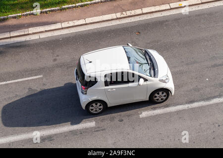 Nice, France - August 13, 2018: White Toyota iQ is on the road at sunny day, top view. It is a transverse engined, front-wheel-drive compact city car