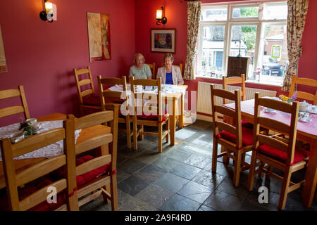 Two women in a tea shop wait to be served Stock Photo