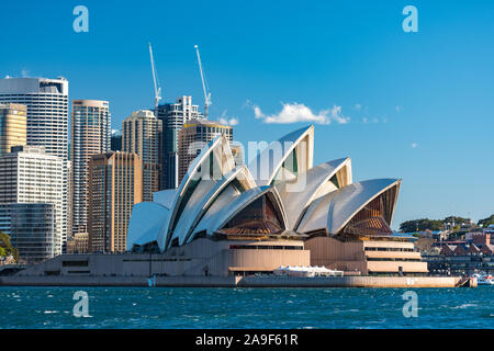 Sydney, Australia - July 23, 2016: Sydney Opera house close up with office buildings of Sydney Central Business District on the background. Circular Q Stock Photo