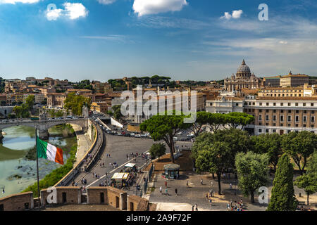 Beautiful view from Castel Sant'Angelo on italian flag, tourists walking, Tiber river and Vatican at the background.  Beautiful sunny weather in Rome Stock Photo