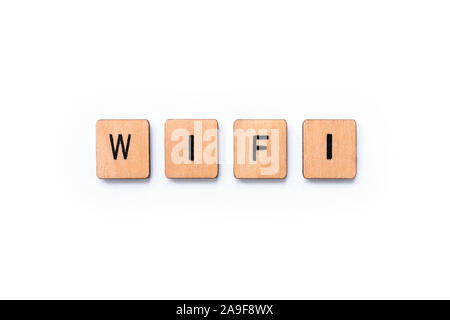 The word WIFI, spelt with wooden letter tiles over a white background. Stock Photo