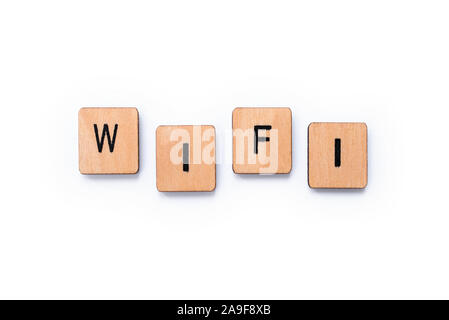 The word WIFI, spelt with wooden letter tiles over a white background. Stock Photo