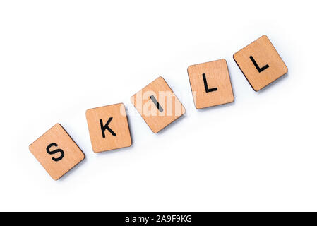 The word SKILL, spelt with wooden letter tiles over a white background. Stock Photo