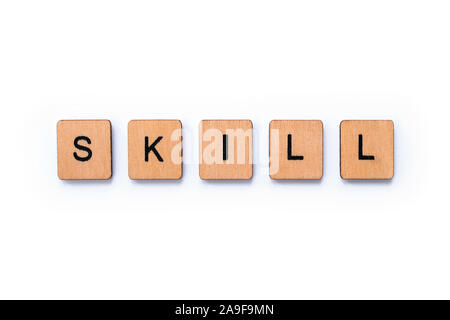 The word SKILL, spelt with wooden letter tiles over a white background. Stock Photo