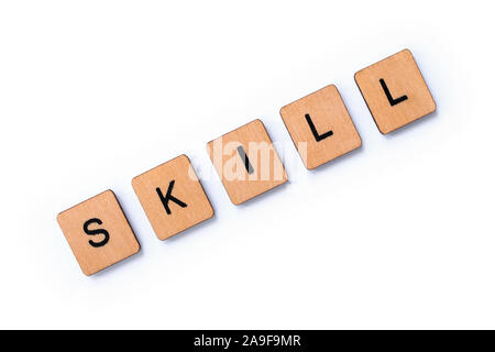 The word SKILL, spelt with wooden letter tiles over a white background. Stock Photo