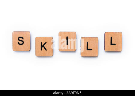 The word SKILL, spelt with wooden letter tiles over a white background. Stock Photo