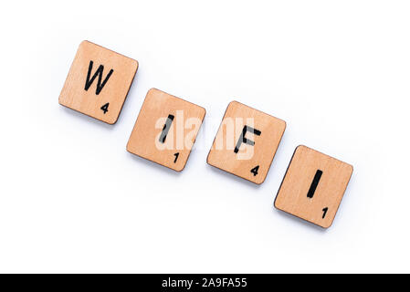 London, UK - June 12th 2019: The word WIFI, spelt with wooden letter tiles over a white background. Stock Photo