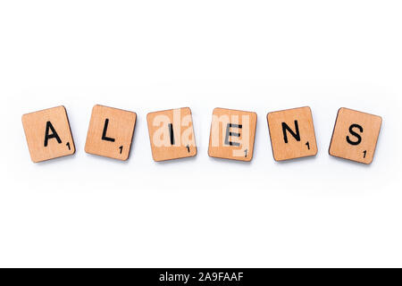 London, UK - June 12th 2019: The word ALIENS, spelt with wooden letter tiles over a white background. Stock Photo
