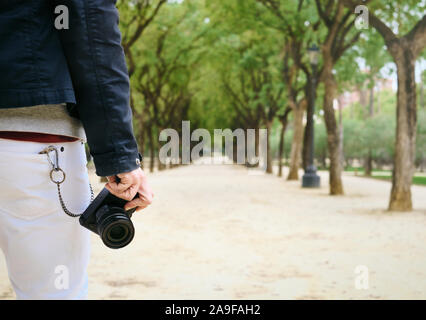 Hipster Street Photographer Walking With Mirrorless Camera In Hand Stock Photo