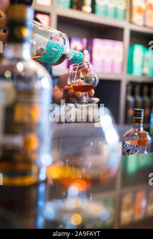 Rhum HSE, rum distillery, tasting, bottle, glass, pour in, Stock Photo