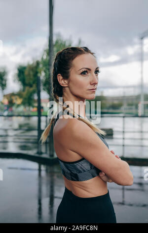 Sportswoman posing arms crossed Stock Photo