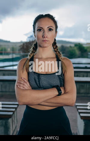 Sportswoman posing arms crossed Stock Photo
