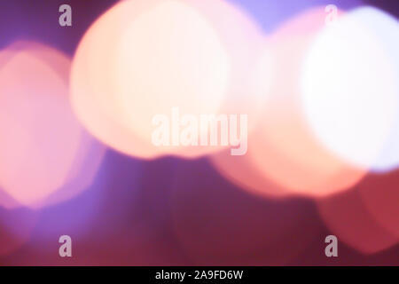 Abstract blurred background with big bokeh colorful circles. City lifestyle backdrop made with street lamps and garland lights Stock Photo