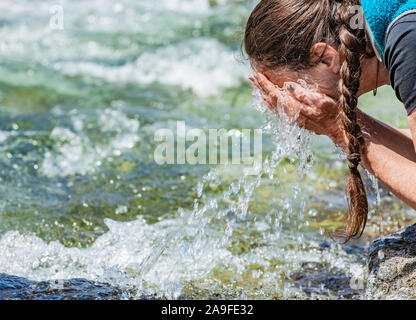 Fresh drinking water from the spring stream Stock Photo