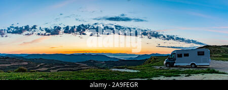 Mobile home on a hill at sunrise Stock Photo
