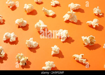 Flat lay composition with popcorn on orange background, closeup Stock Photo