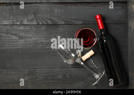 Flat lay composition with bottle of wine, glasses and corkscrew on wooden background, copy space Stock Photo