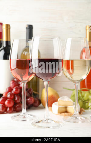 Fruits, cheese, bottles and glasses with different wine on white background, space for text Stock Photo