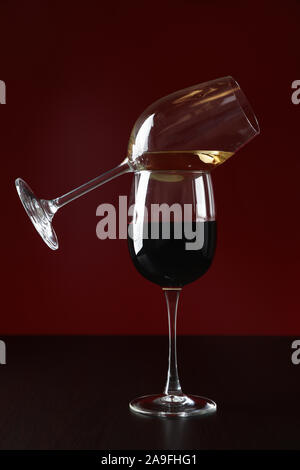 Glasses with wine against red background, copy space Stock Photo