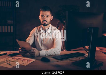 Photo of thoughtful serious business people holding tablet with hands listening attentively to employee noting his words down thoughtful about taking Stock Photo