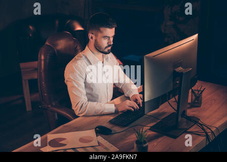 High angle view photo of pensive thoughtful man concentrated on analyzing information and involving received knowledge into newly developed project Stock Photo