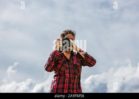 Photographer on a mountain top Stock Photo