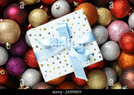 Present on christmas balls background, top view Stock Photo