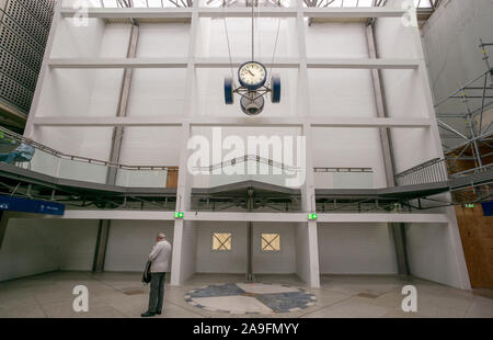 Munich, Germany. 15th Nov, 2019. A man stands in front of a raised barrier in the main station. The large entrance hall used to stand behind the wall and was completely demolished. Credit: Peter Kneffel/dpa/17�Թ����� Live News Stock Photo