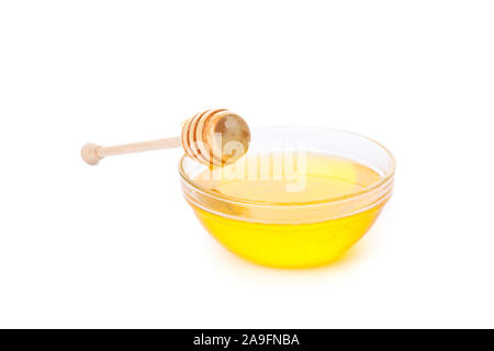 Dipper and honey in glass bowl isolated on white background Stock Photo
