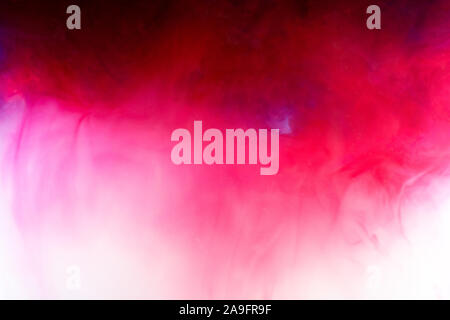 Background with red ink and soft pink mixing in the liquid Stock Photo