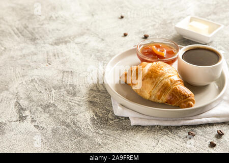breakfast with croissants. fresh crispy croissants and coffee on a light  background, top view/ Stock Photo