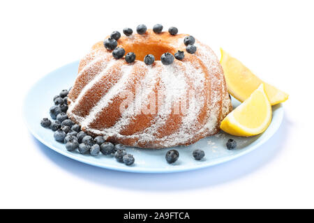 Cake with powdered sugar, blueberry and lemon isolated on white background Stock Photo