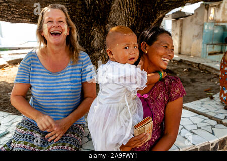 A Burmese Child Is Frightened At The Sight Of A Caucasian Female Tourist The Kuthodaw Pagoda, Mandalay, Myanmar. Stock Photo